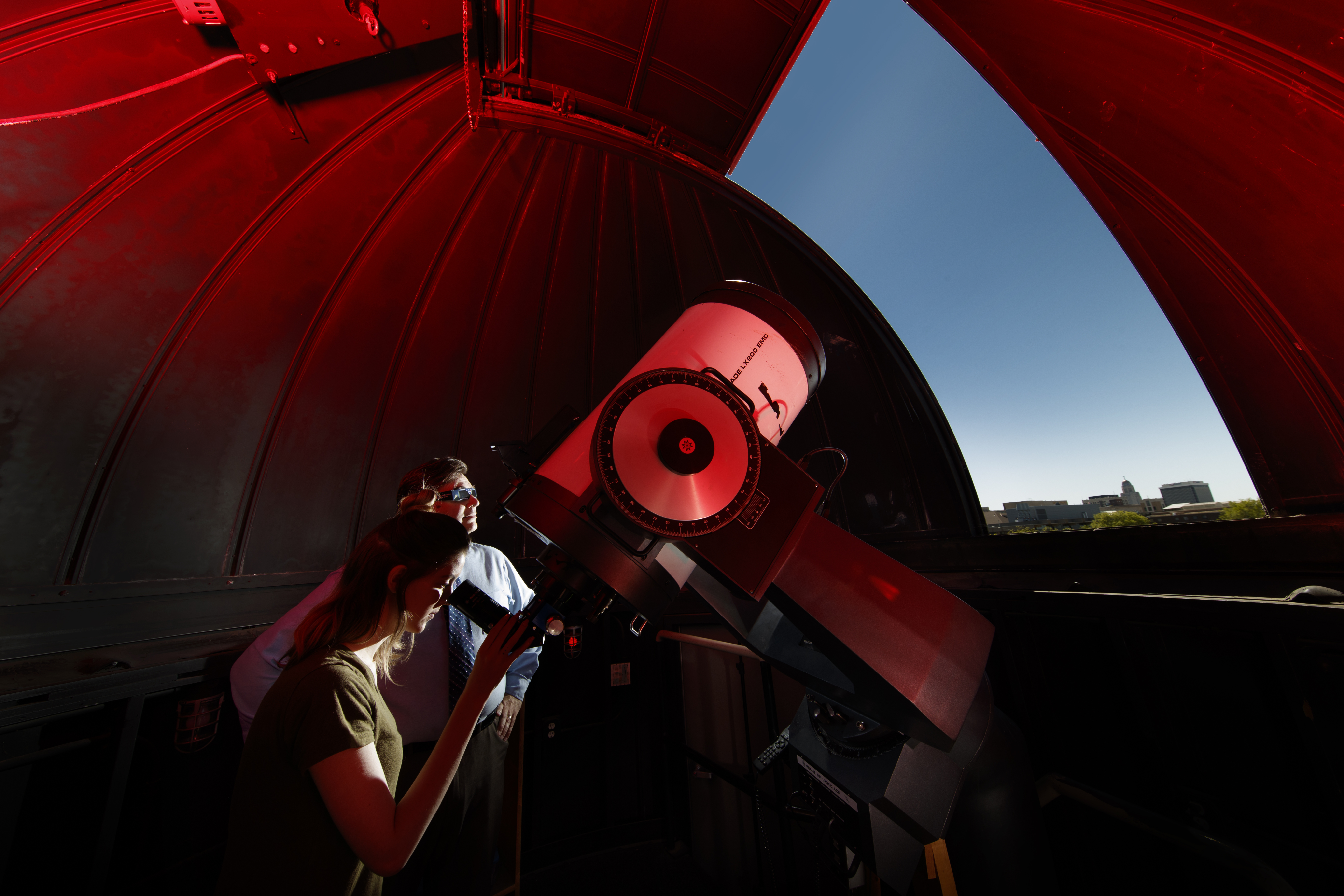 Michael Sibbernsen (right) and Hannah Paxton use the observatory atop the Stadium Parking Garage at the University of Nebraska–Lincoln. The university will use the observatory to record the Aug. 21 total solar eclipse.