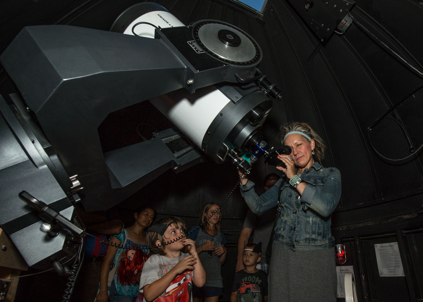 Visitors look through a telescope at the UNL Student Observatory as part of "Archie’s Late Night Party" in 2015.