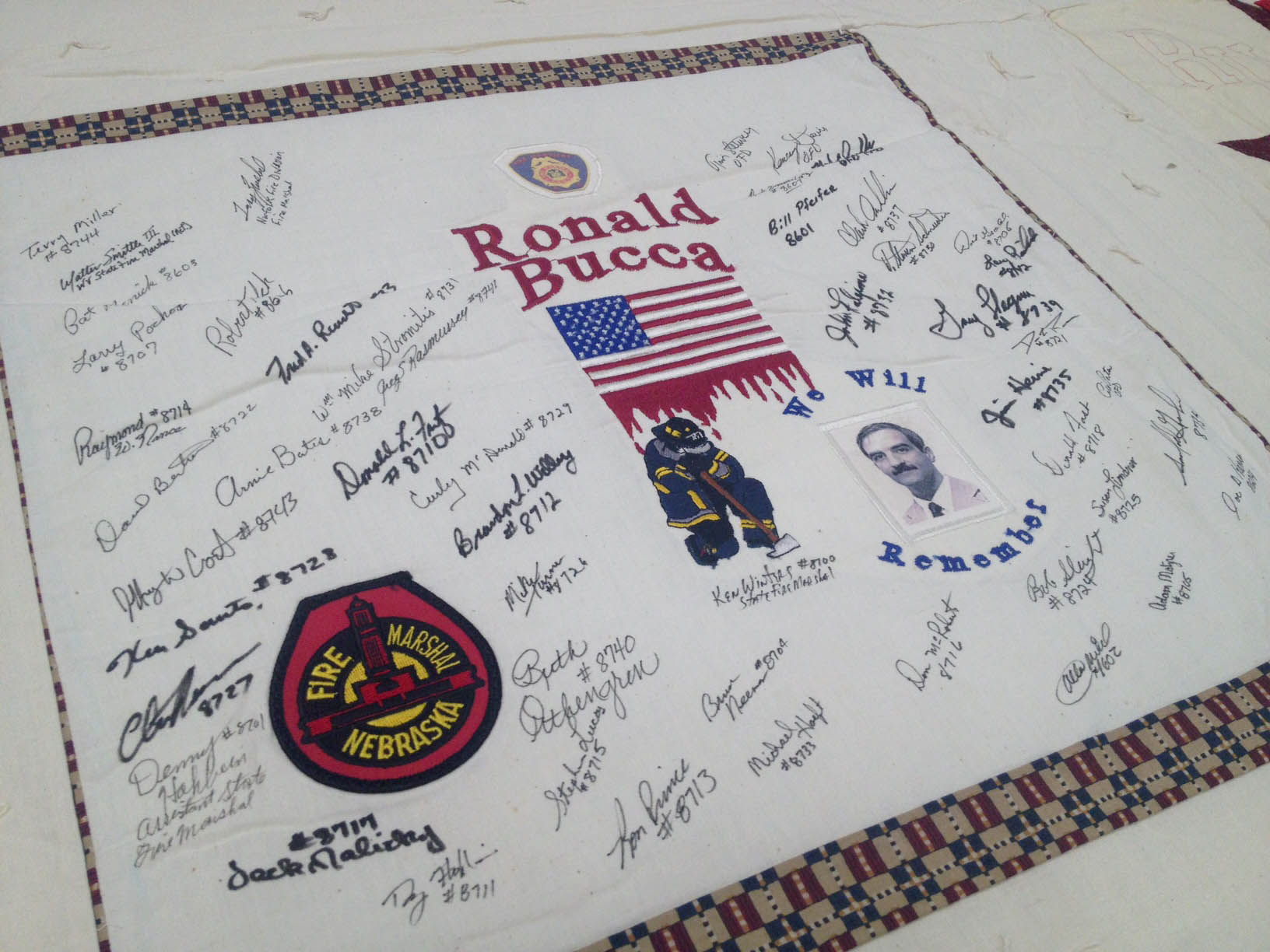 The memorial quilt includes a block for Ronald Bucca, a New York City fire marshal who was killed after ascending the World Trade Center's South Tower during rescue operations on Sept. 11, 2001. The block, which features a Nebraska Fire Marshal logo, also will be part of the quilt center exhibition.