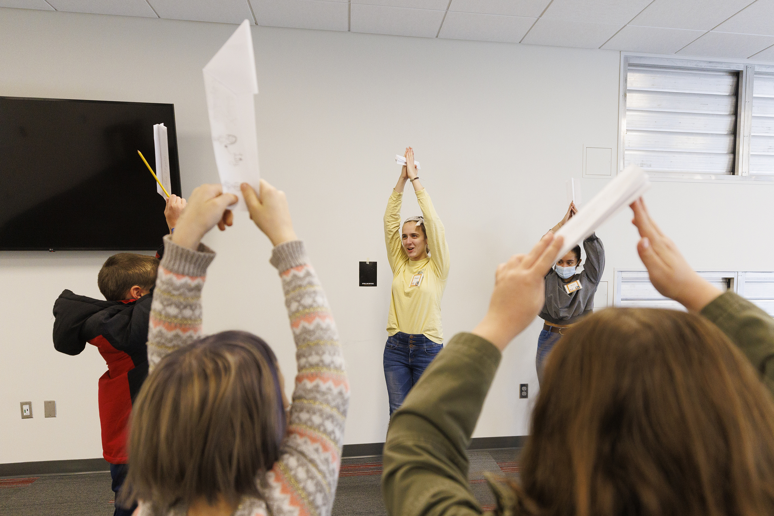 Students pretend they are pencils in an ice-breaking exercise led by Meagan Heimbrecht during a "Galactic Quest" workshop at the Crete Public Library.