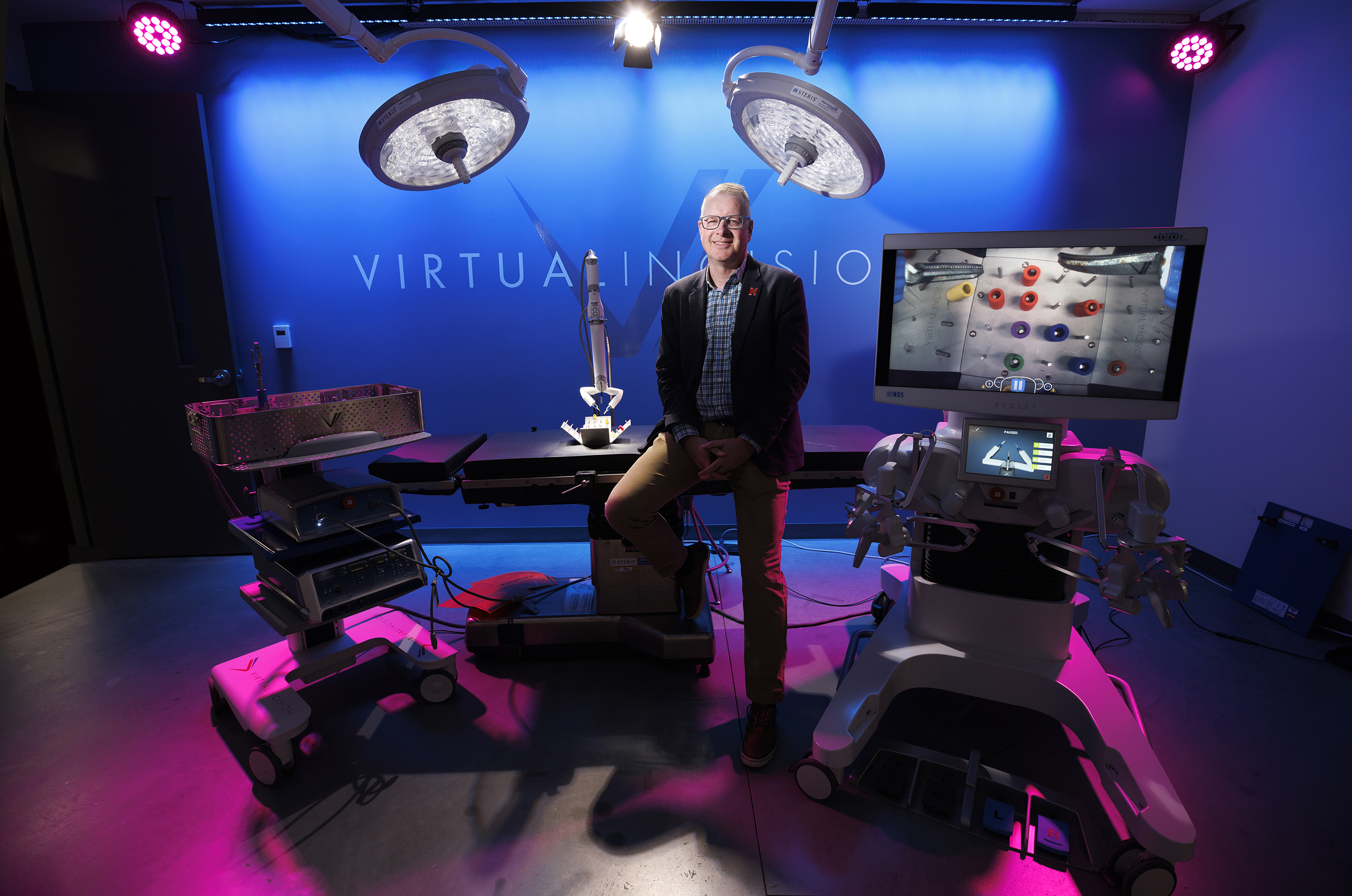 Shane Farritor, the David and Nancy Lederer Professor of Engineering and chief technology officer of Virtual Incision, stands in a laboratory with a surgical robot.