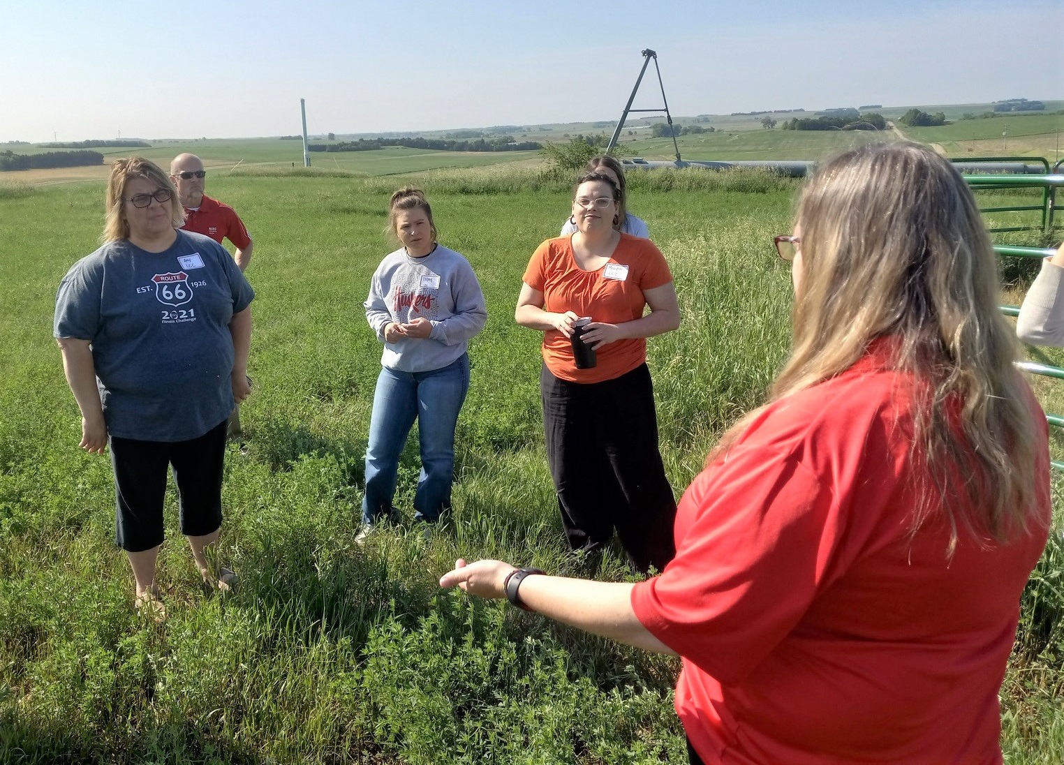 Several teachers stand in a field near the Haskell Agricultural Laboratory.