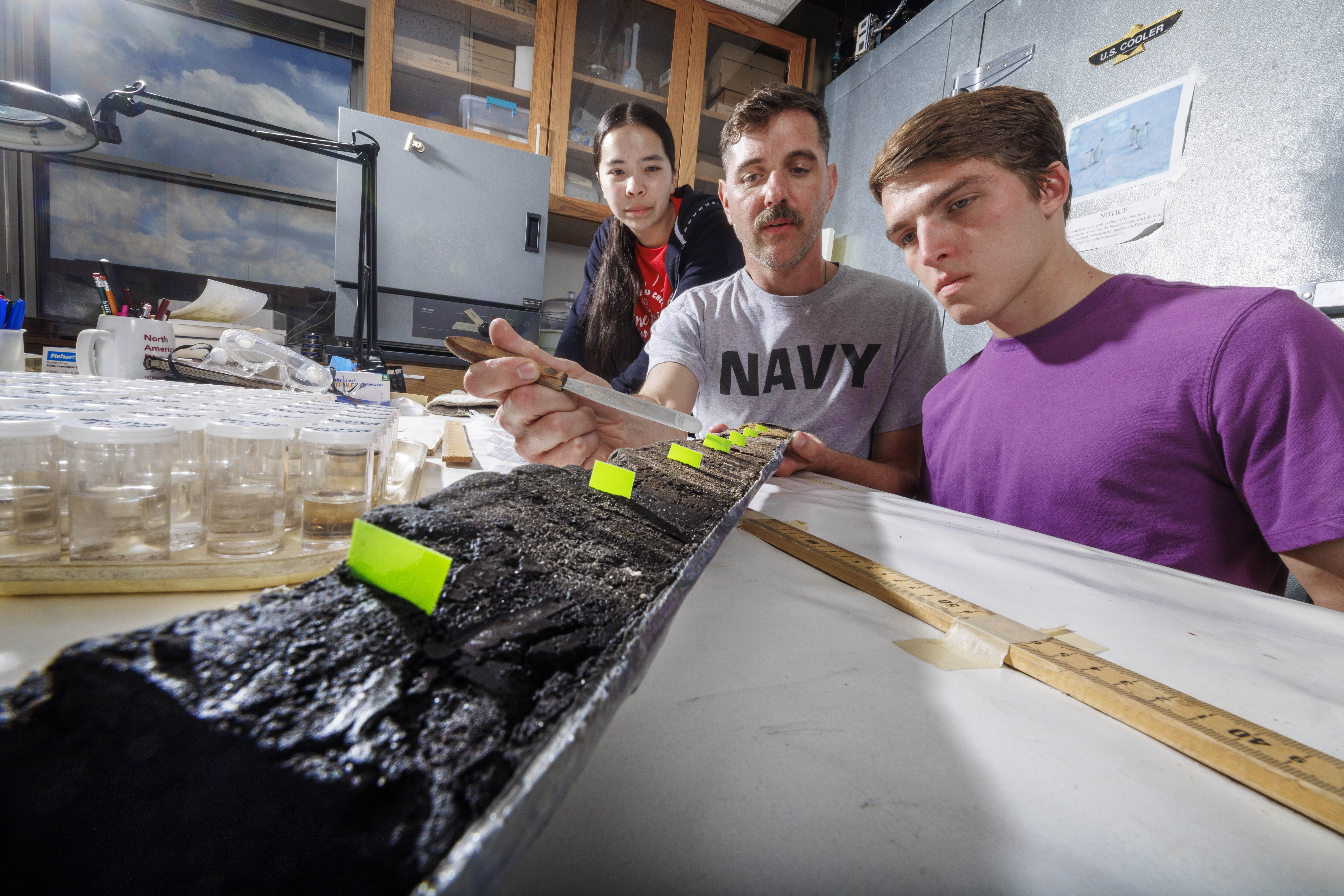 Doctoral student Jim Benes and UCARE students Jasmine Pham and Joe Stalder pose with charcoal samples from the Nebraska Sandhills.