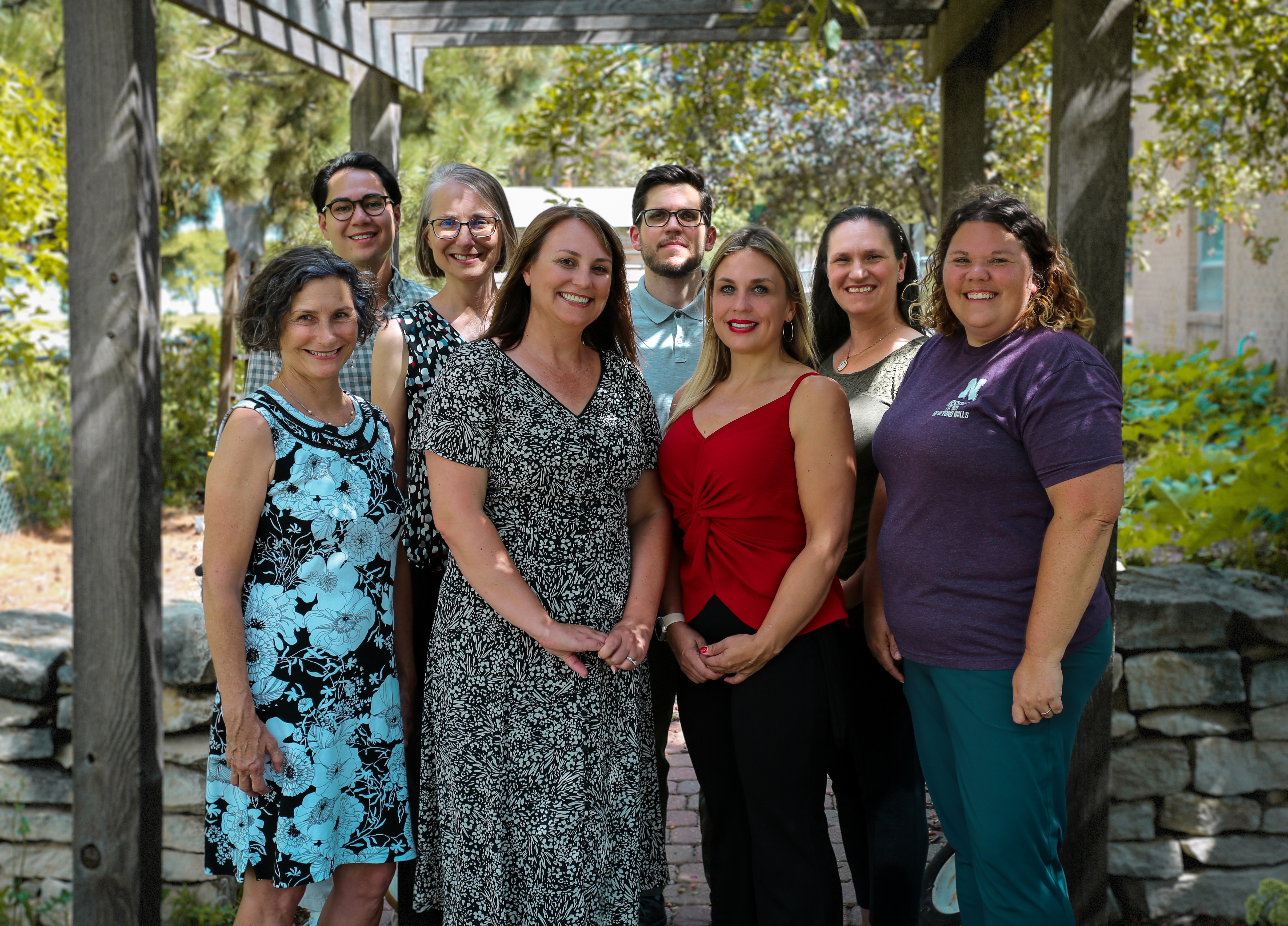 Outdoor group photo with eight Husker researchers