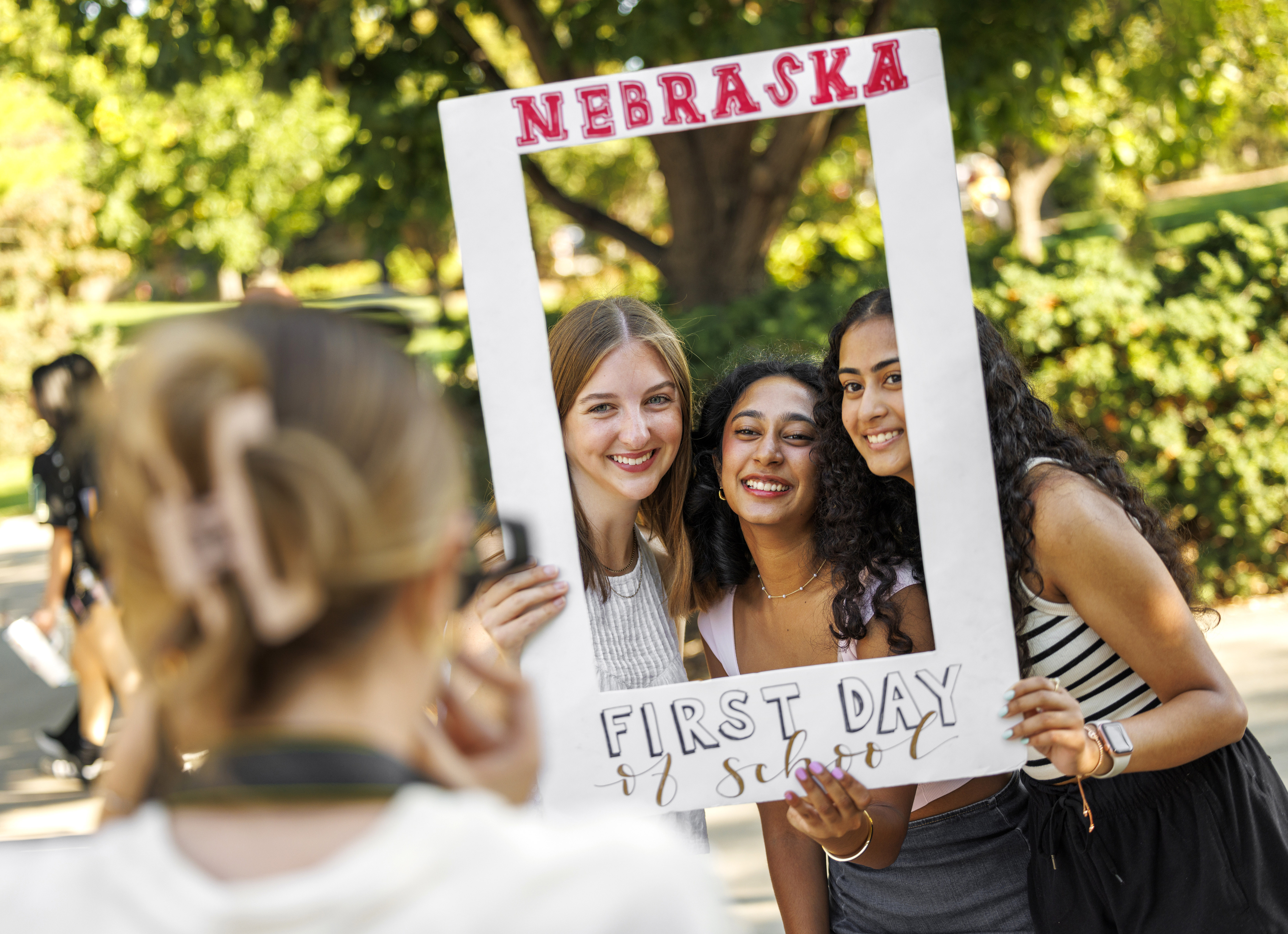 Freshman Makenna Jolley (left) and sophomores Anisha Patchipulusu (center) and Shayna John pose for a photo near the Nebraska Union on the first day of fall classes, Aug. 26.