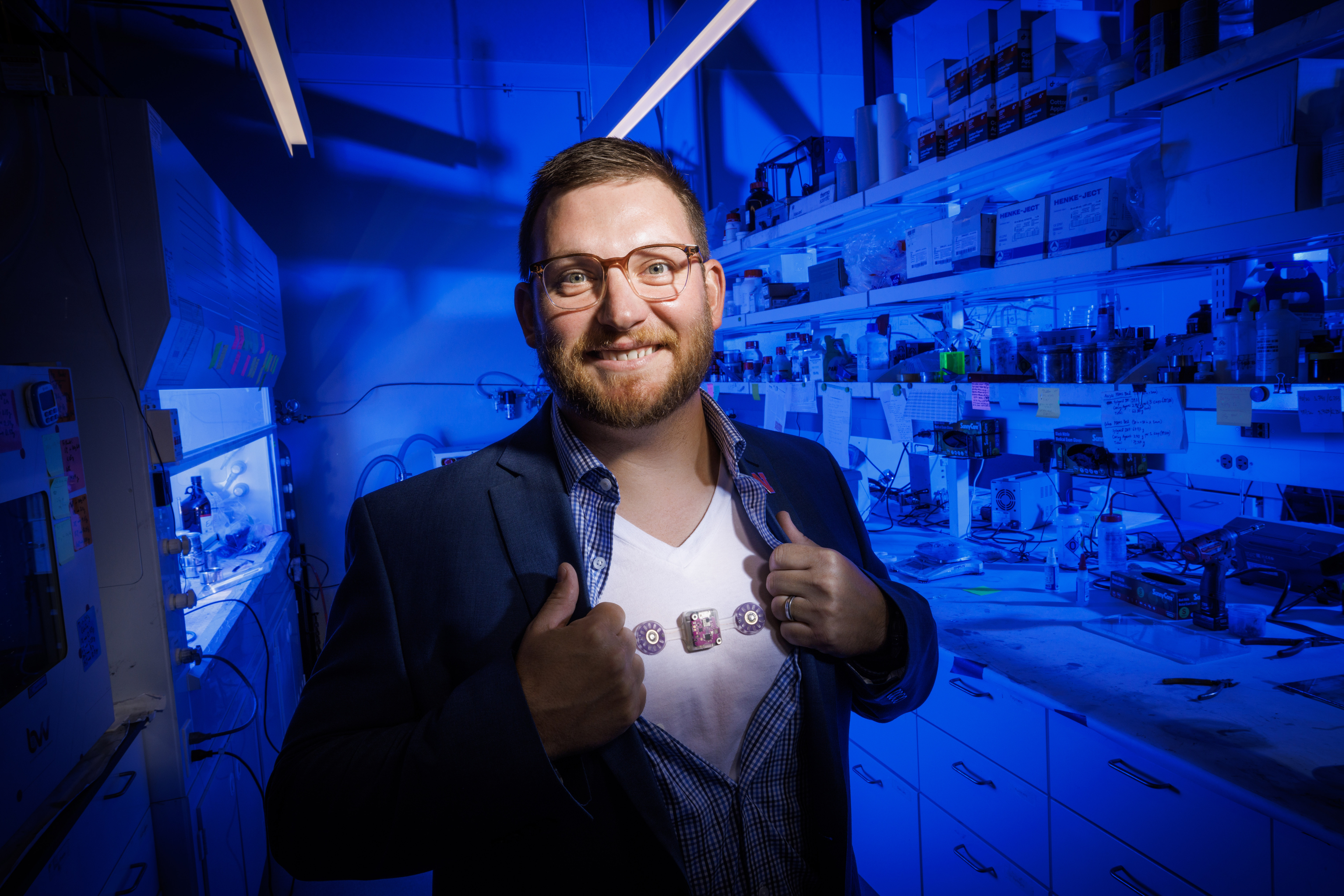 Eric Markvicka, Krohn Assistant Professor of Biomedical Engineering, displays the wearable monitoring device he is helping develop. The device is attached to his undershirt.