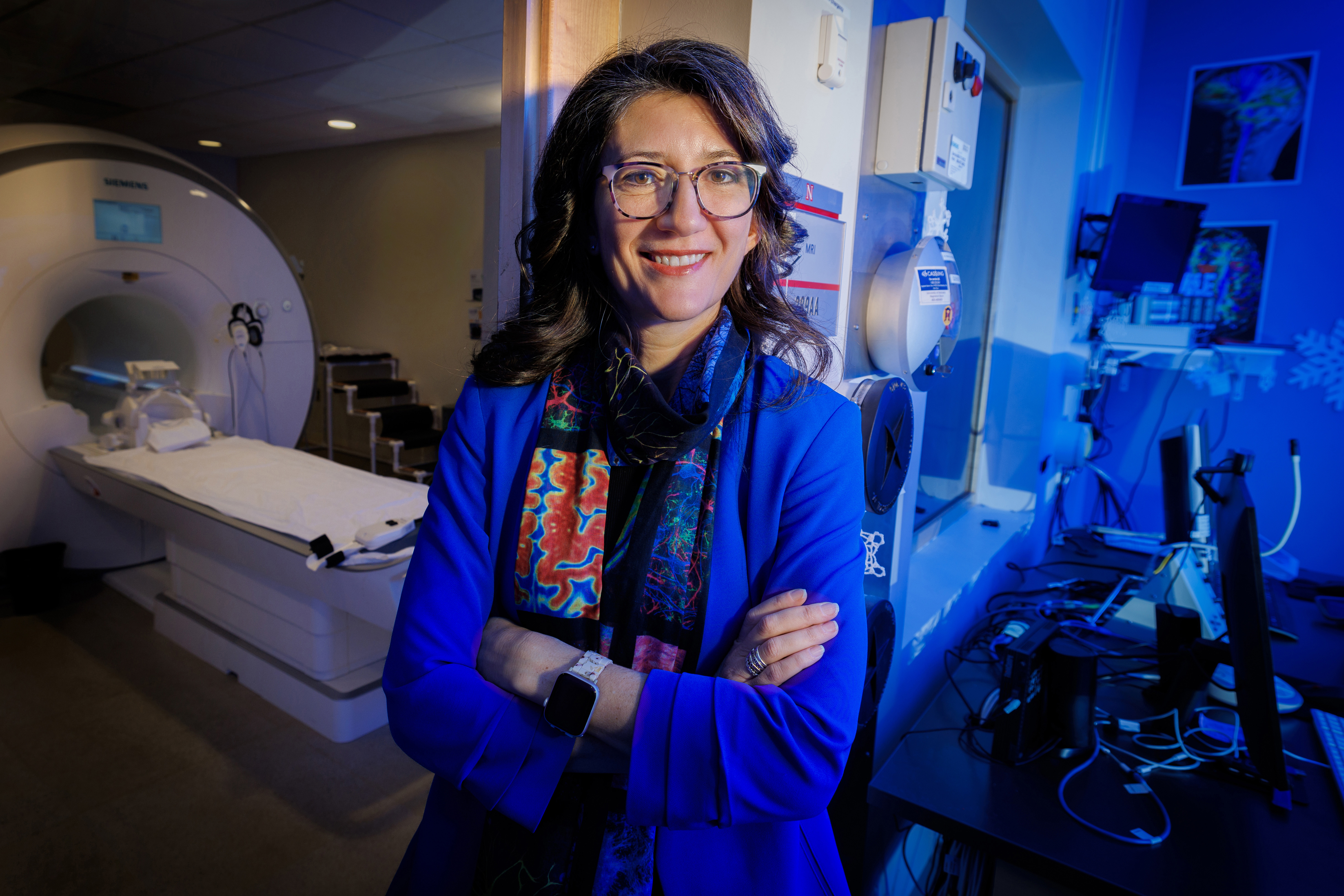 Maital Neta, professor of psychology, poses for a portrait inside the Center for Brain, Biology and Behavior's MRI room.