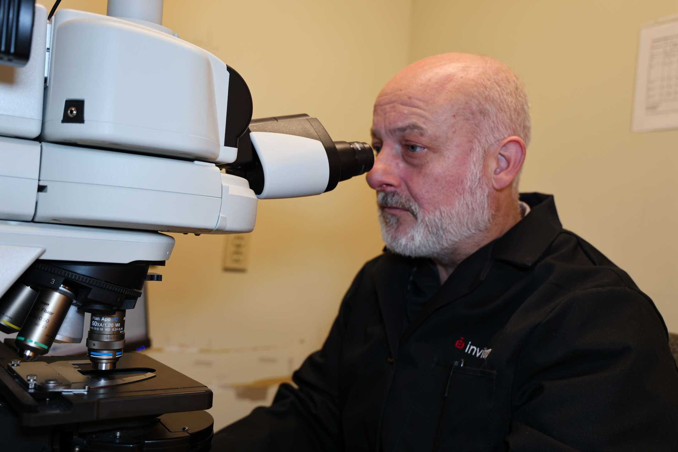 Richard Wilson, Charles Bessey Professor of plant pathology, looks through a microscope.