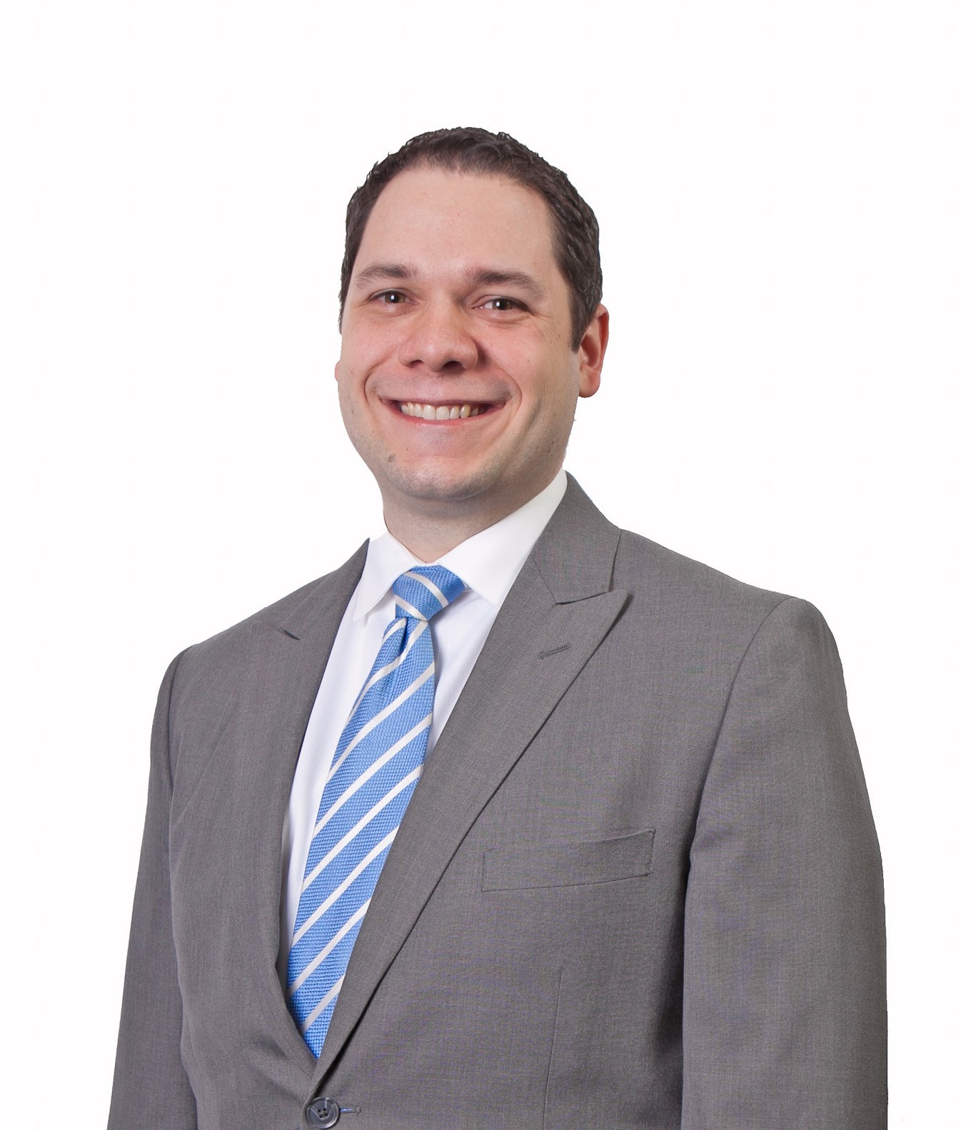 Color portrait of Neil Linscheid, wearing a gray suit jacket with a white dress shirt and light blue, diagonally striped tie.