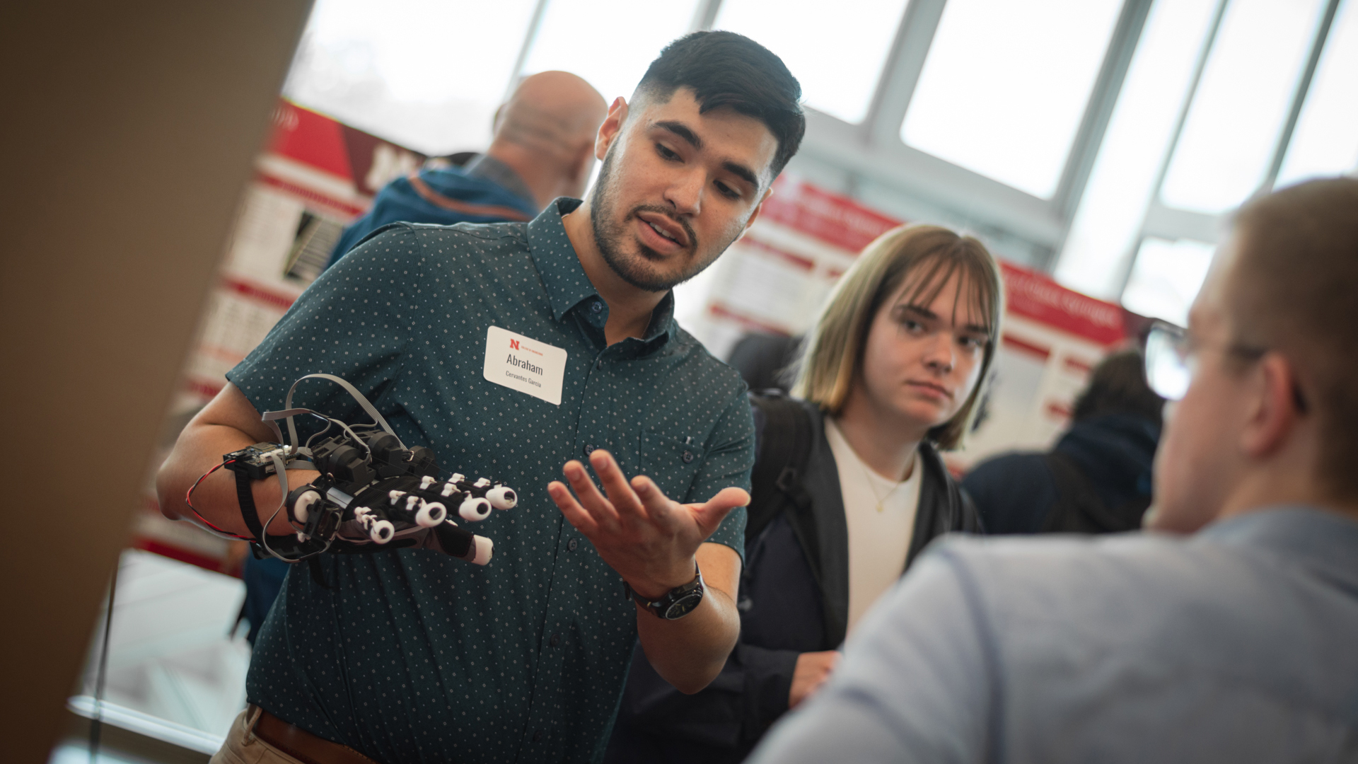 Abraham Cervantes Garcia demonstrates his team’s robotic glove during the 2025 Senior Design Showcase at Kiewit Hall. The project won the People’s Choice Award. The 2026 showcase is April 24.