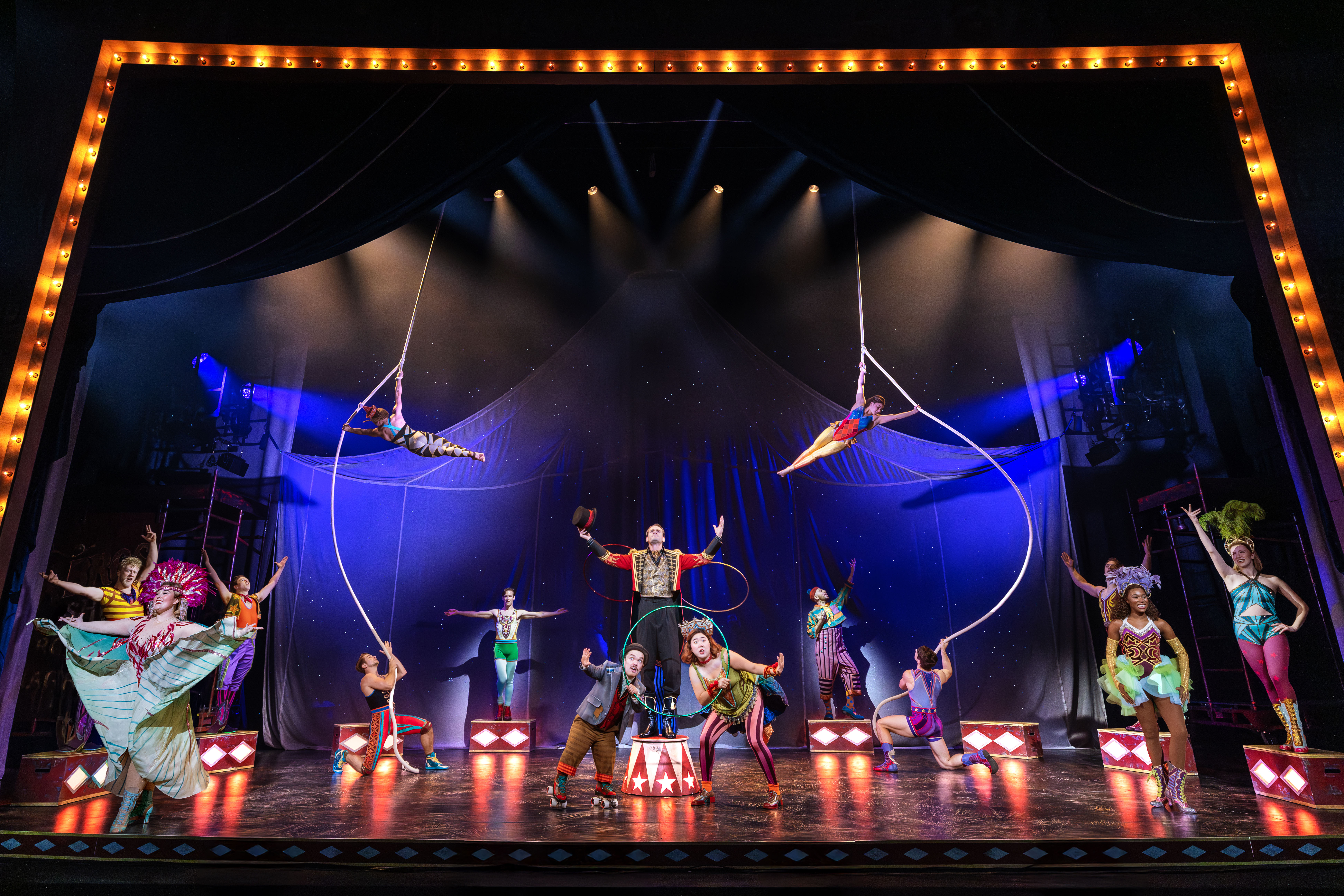 Acrobats and circus performers on a stage.