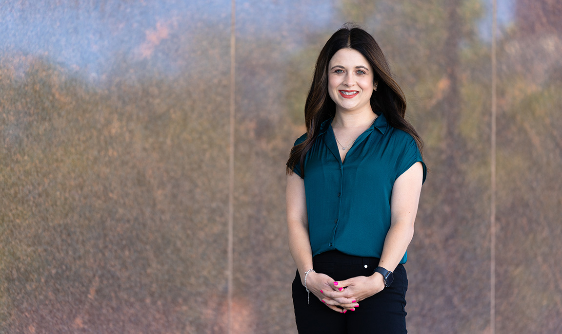 Ciera Kirkpatrick, assistant professor in the College of Journalism and Communications, is photographed by the granite walls outside Andersen Hall.