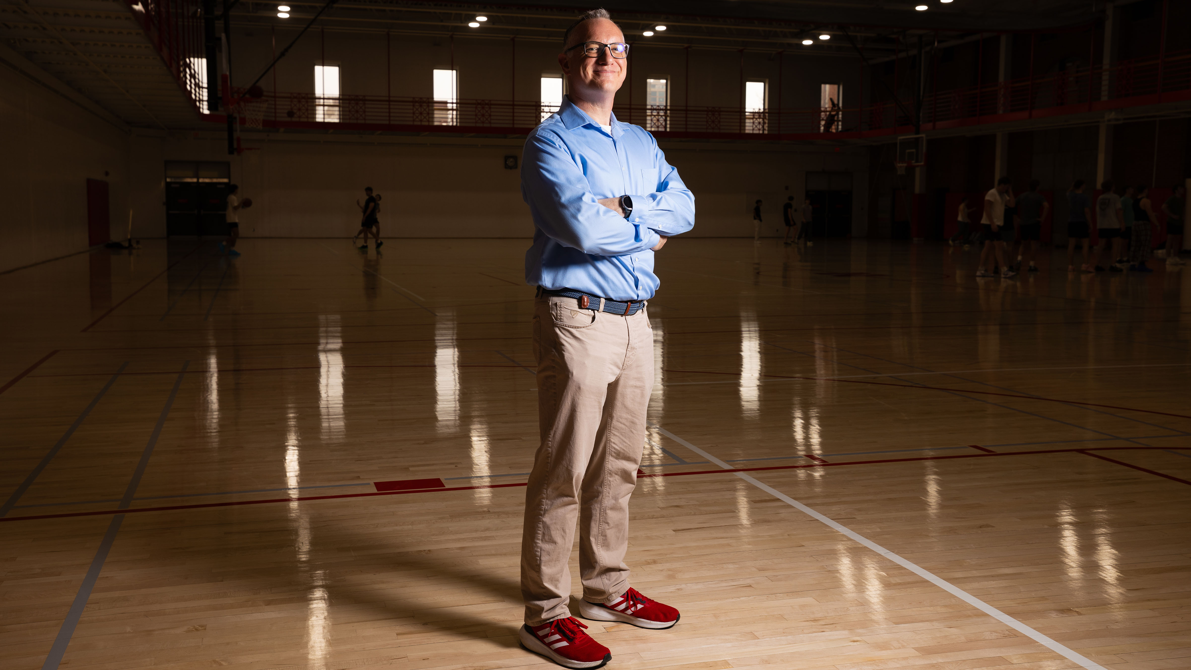 A man stands on a basketball court.
