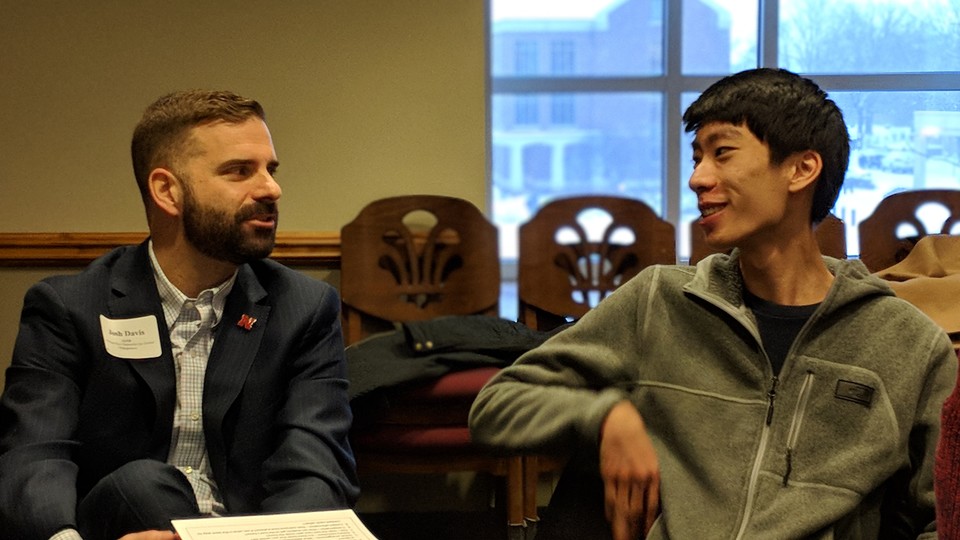 Josh Davis, IANR assistant vice chancellor for global engagement, meets one of his assigned students at a Dinner in a Nebraska Home reception in Spring 2018. 