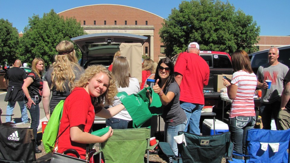  Courtesy photo | A volunteer from the "Go Green for Big Red" initiative hands out recycling bags during a Husker home football game. Volunteers are being sought for the 2016 season.