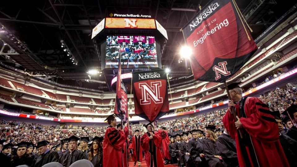 Member of UNL's commencement marshal corps carry college gonfalons into Pinnacle Bank Arena at the start of commencement exercises in Pinnacle Bank Arena. The Nebraska Alumni Association hosts a two-day celebration for December 2015 graduates, Dec. 1-2 at the Wick Alumni Center.