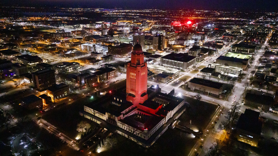 The Nebraska State Capitol building shines red in support of Glow Big Red in 2019.
