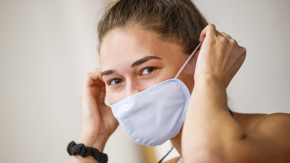 Olivia Boldt, senior from Madison, South Dakota, puts on her mask before going to work out. June 15, 2020. Photo by Craig Chandler / University Communication