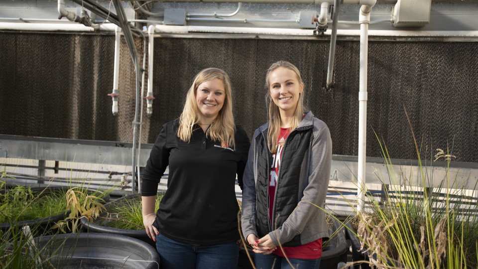 Alexa Davis, (right) graduate student with the School of Natural Resources, and Tiffany Messer, assistant professor and water quality engineer at the University of Nebraska-Lincoln, in the Messer Laboratory surrounded by floating wetland experiments on De