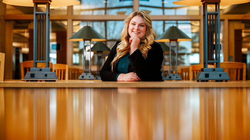 Delaney Doyle poses for a photo in the Marvin & Virginia Schmid Law Library