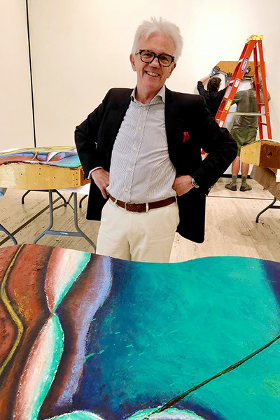 Wally Mason is seen with Elizabeth Murray's "Wishing for the Farm," shown in three parts during installation.