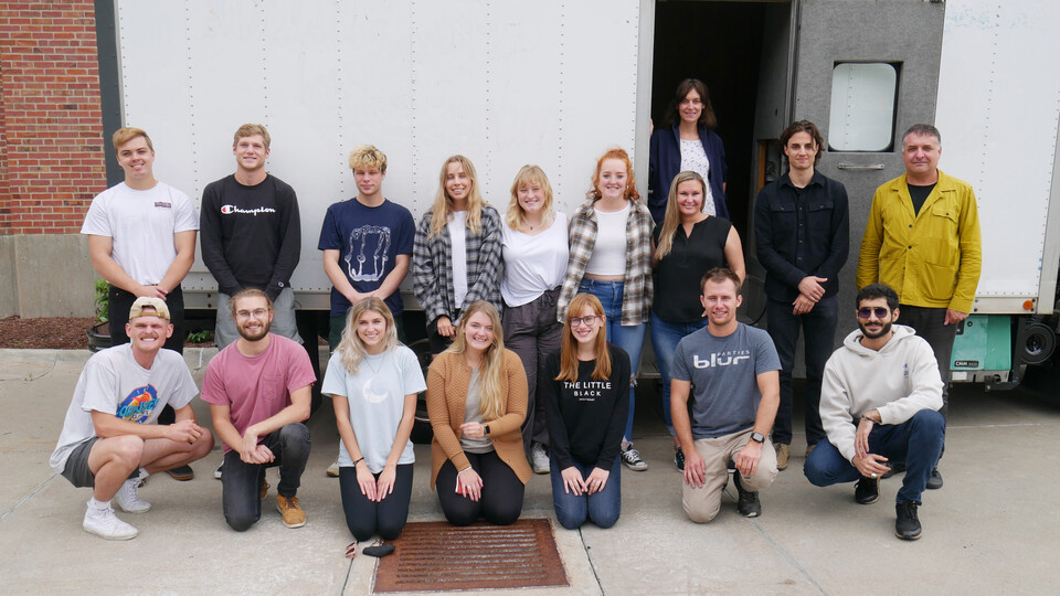 FACT studio students pose in front of their Omaha Mobile Stage
