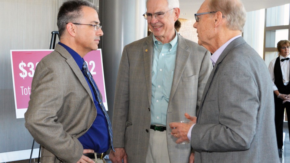 NDMC director Mike Hayes (left) and NDMC founder Don Wilhite (right) talk with Sen. Ken Haar during the center's 20th anniversary celebration on Friday at the International Quilt Study Center and Museum.