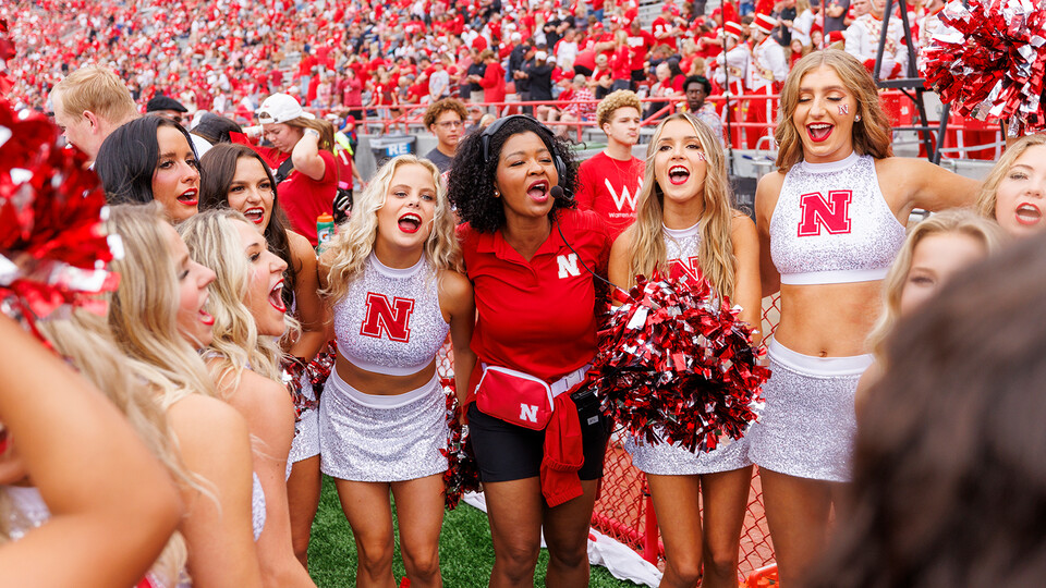 Nebraska's Erynn Butzke (center, in red), celebrates with the Scarlets dance squad along the sidelines of Memorial Stadium during the Oklahoma game on Sept. 17.