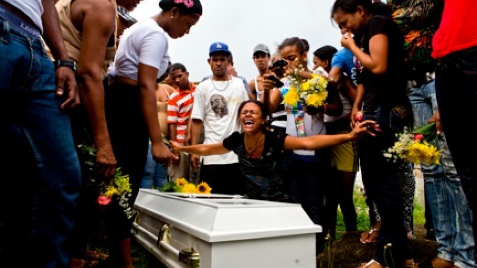 Friends and family mourn the loss of Aneuris Polanco Foxan at Cristo Rey Cemetery. In order to bury Foxan the family had to exhume Smiley Danni Foxan. "We don't have the space and money for another niche," said Hector Williams Foxan.