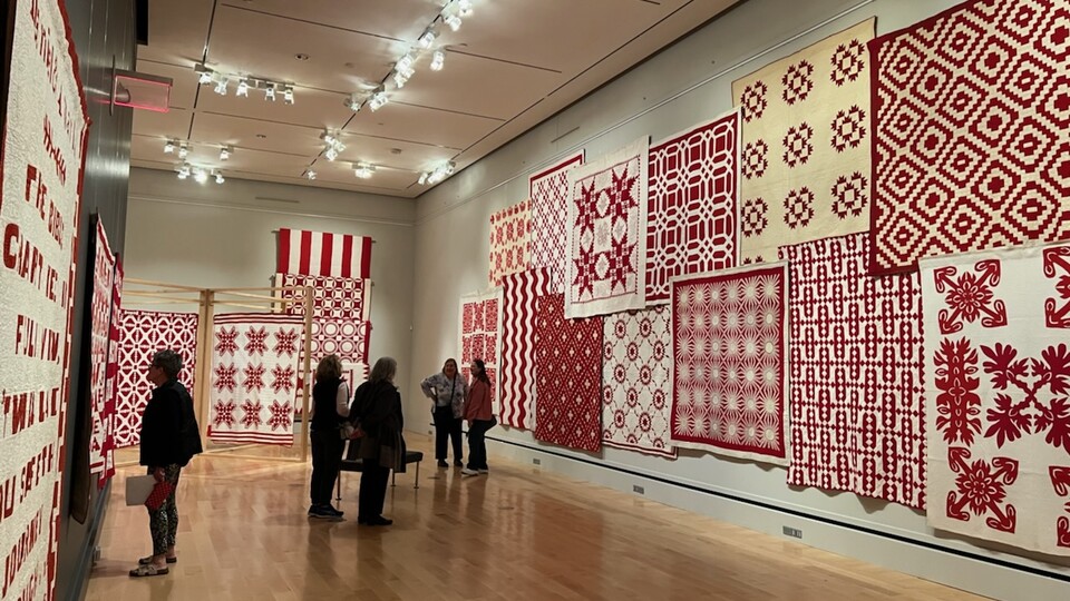 Wall of Joanna S. Rose's Red and White quilts 