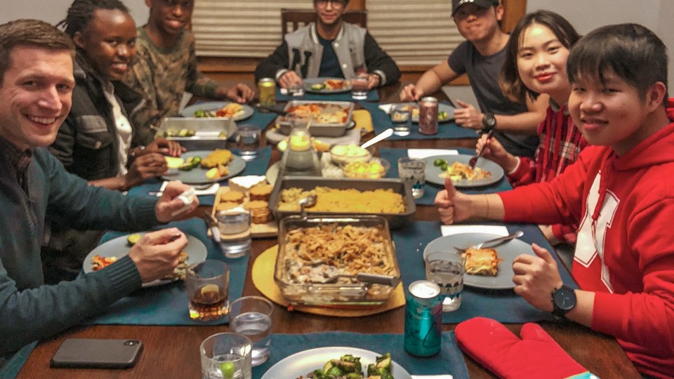 International students from four different countries were enjoying dinner at a faculty's home. 