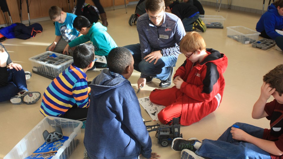 Nebraska student Colton Harper mentors students at Culler Middle School as part of a robotics club formed in January.