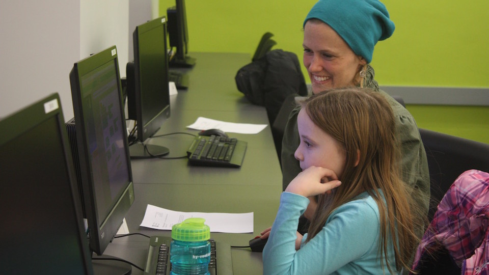 Mentor Gretchen Larsen helps an LPS middle schooler, Brynn, develop her coding skills at the first CADDY workshop.