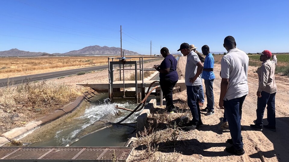 Students observe the water filter of an open canal in the Ak-Chin Indian Reservation, Arizona. 
