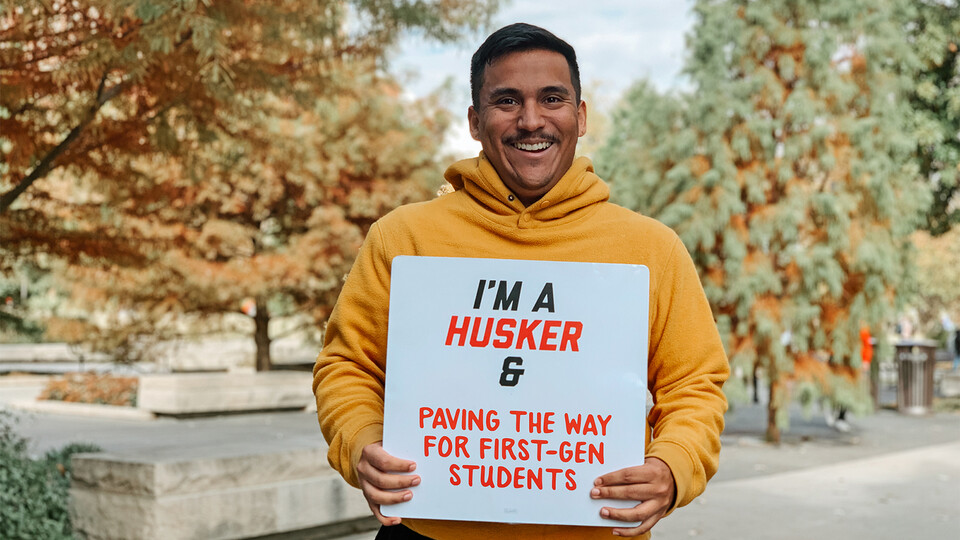 Grajeda holds a sign that reads, "I'm a Husker & Paving the Way for First-Gen Students."