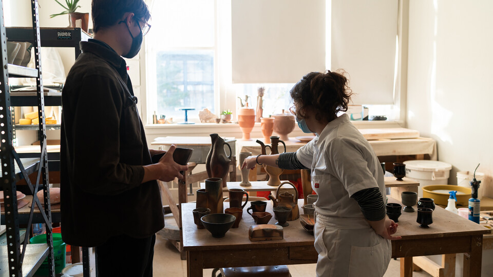 A visitor interacts with a graduate student at a previous Open Studios event. This year’s Open Studios event is Nov. 3. Photo by Eddy Aldana.