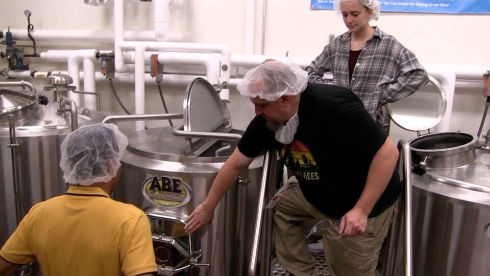 Andy Rasmussen demonstrates the brewing process at the Food Innovation Center pilot plant.