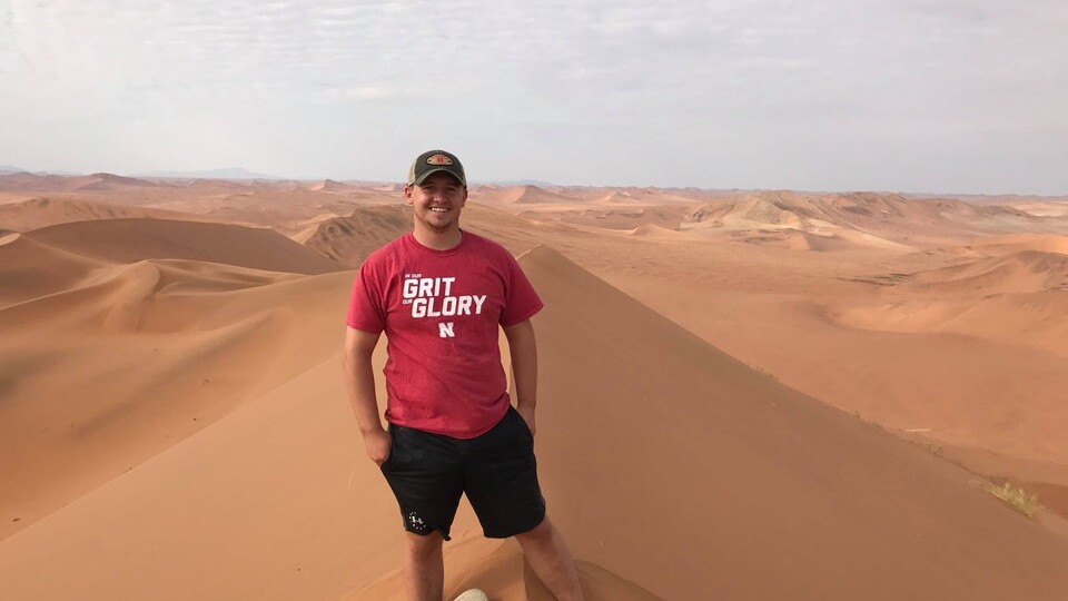A male Husker stands on one of the tallest sand dunes in the world through a study abroad program in Namibia in 2019. Students are invited to explore the multitude of options available through the Education Abroad Office at the Global Experiences Fair on 