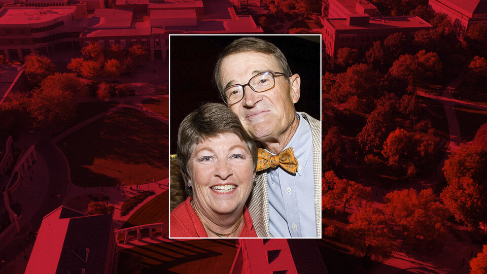 Color photo of Kit and Dick Schmoker on red campus background