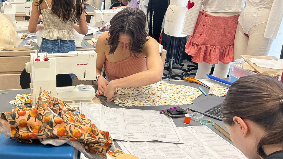 Fashion design students working with fabric