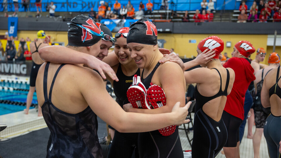 The Husker swimming and diving team celebrates on the opening day of the Big Ten Championships