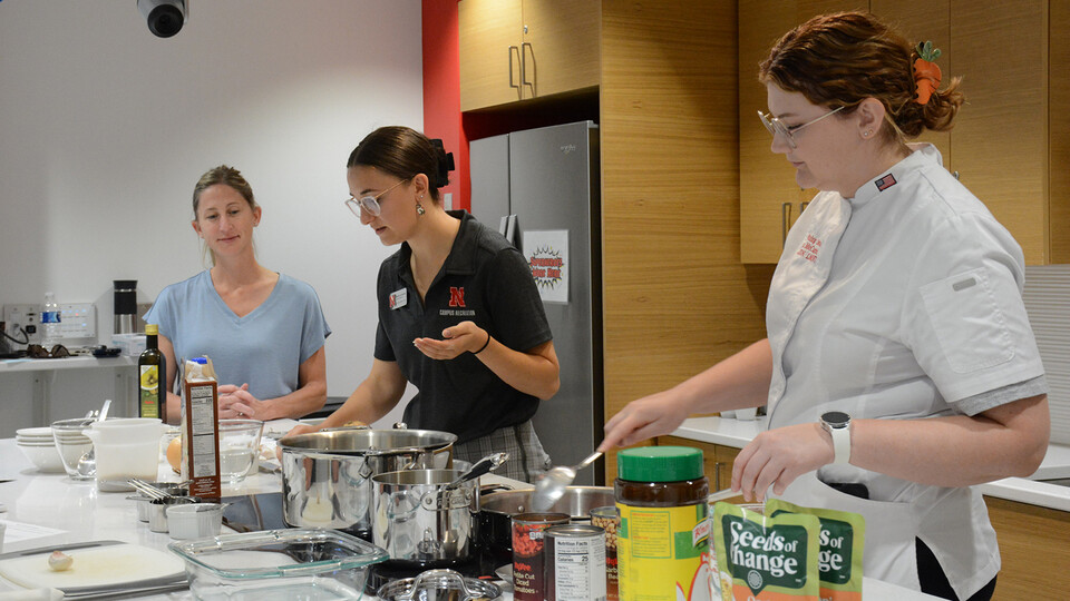 Registered dietitians prepare a meal in the kitchen
