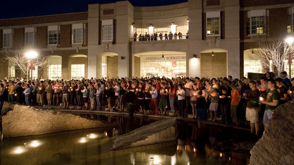 Students stand around Broyhill Fountain outside the Nebraska Union during a 2007 candlelight vigil held in response to a campus shooting at Virginia Tech. UNL will host an April 10 memorial at Broyhill Fountain to celebrate the lives of students who have died this academic year.