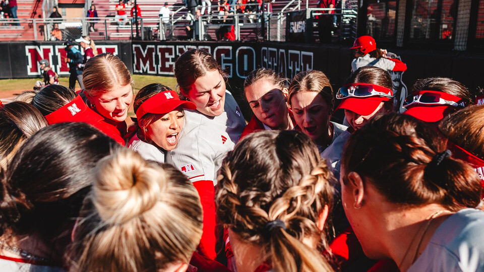 Husker softball huddles up following a victory over the Montana Grizzlies