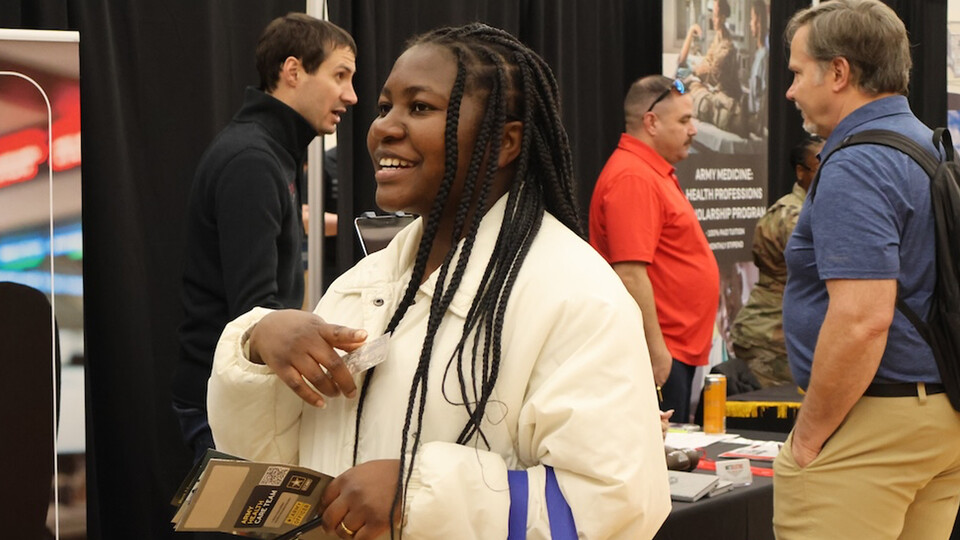 A Husker student chats with a recruiter at a career fair coordinated by Nebraska Engineering