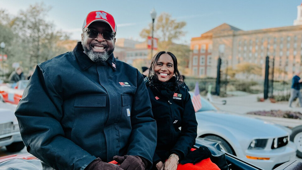 Chancellor Rodney Bennett and wife Temple sit in the back of a convertible during the homecoming parade