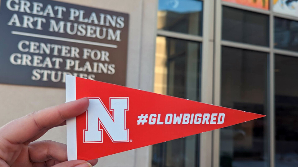 Husker pennant in front of the Center for Great Plains Studies