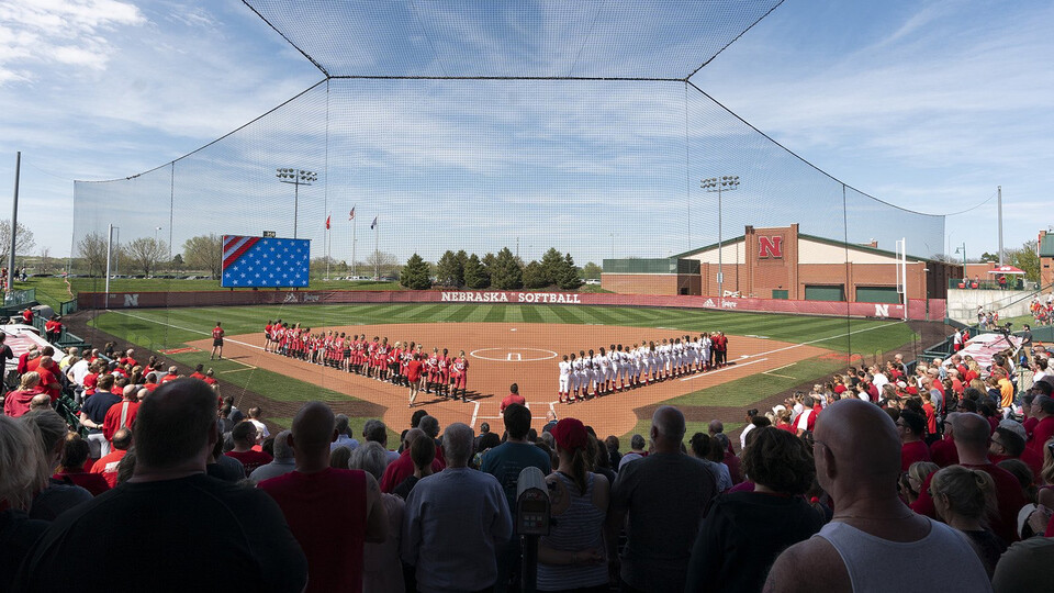 A view of Bowlin Stadium from behind home plate, as players and fans stand for the national anthem