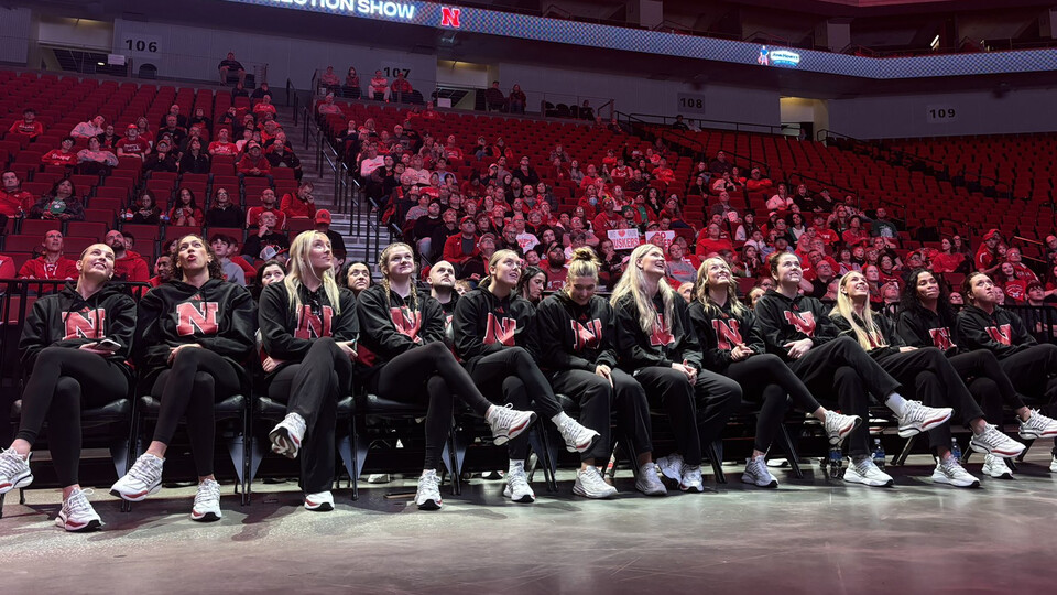 The women's basketball team looks up at a jumbotron while awaiting word of their seeding in the NCAA tournament