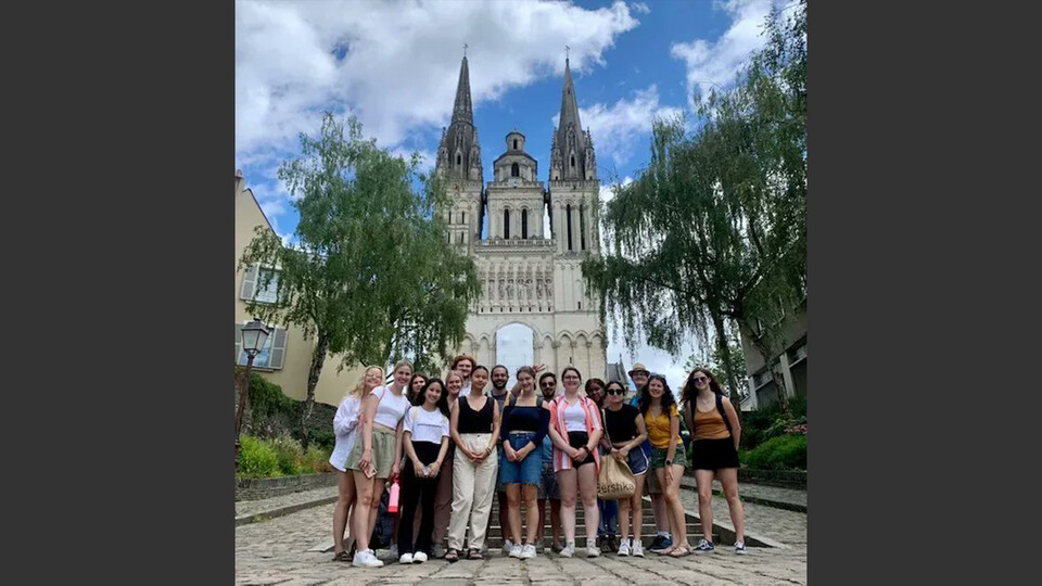  Huskers pose in front of a church during an education abroad experience in Angers, France. The students are immersing themselves in the French language during the month of July. Learn more at https://go.unl.edu/usvq.